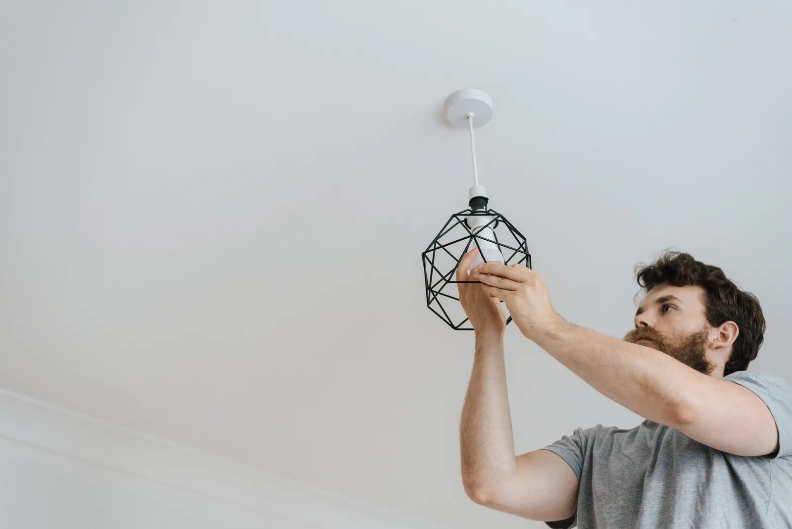 Fitting a lamp into a pendant fixture, for ev charger installation in Buffalo
